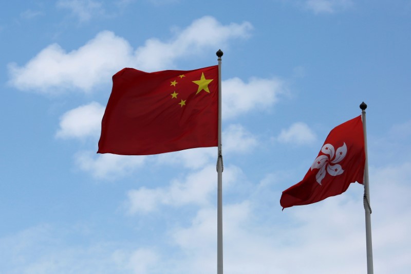 © Reuters. A Chinese national flag and a Hong Kong flag fly outside the Legislative Council in Hong Kong