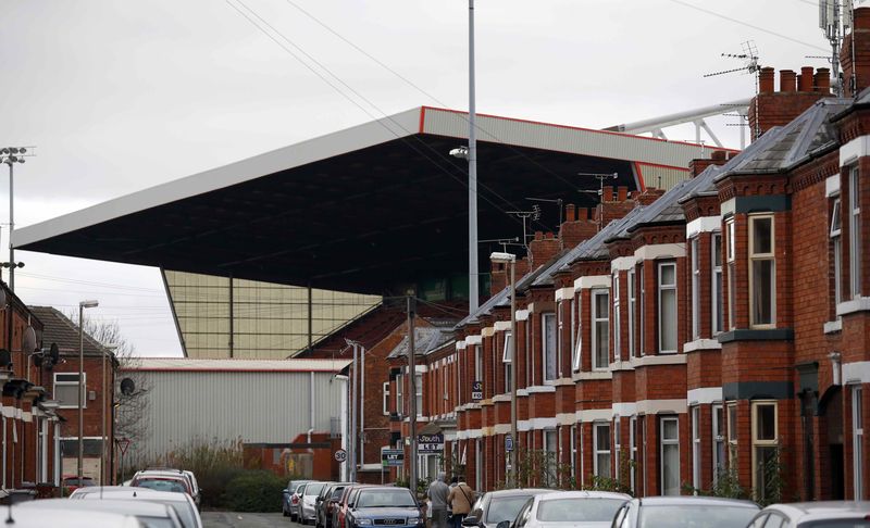 © Reuters. The roof of a stand towers over terraced houses at the Crewe Alexandra Football Club ground in Crewe