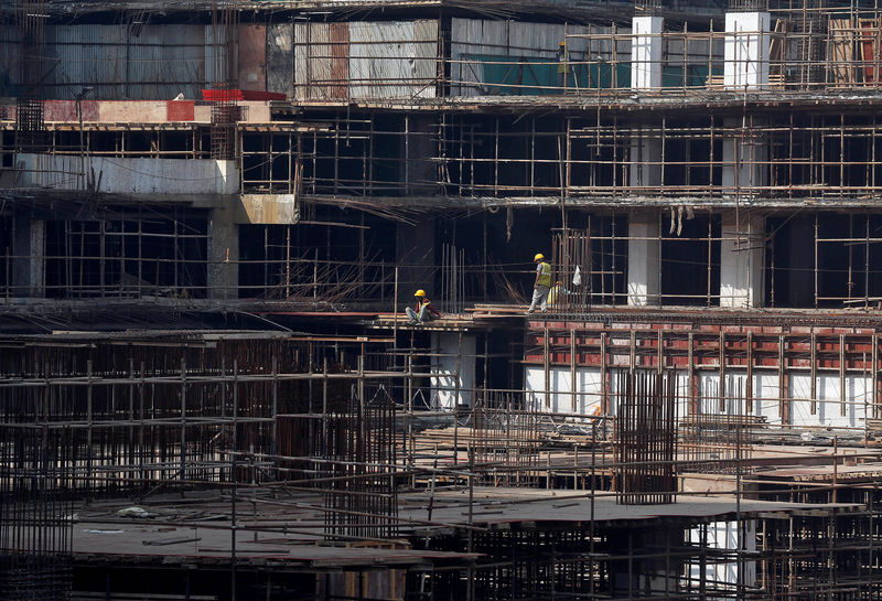 © Reuters. Construction workers work on a site of a residential building in Mumbai