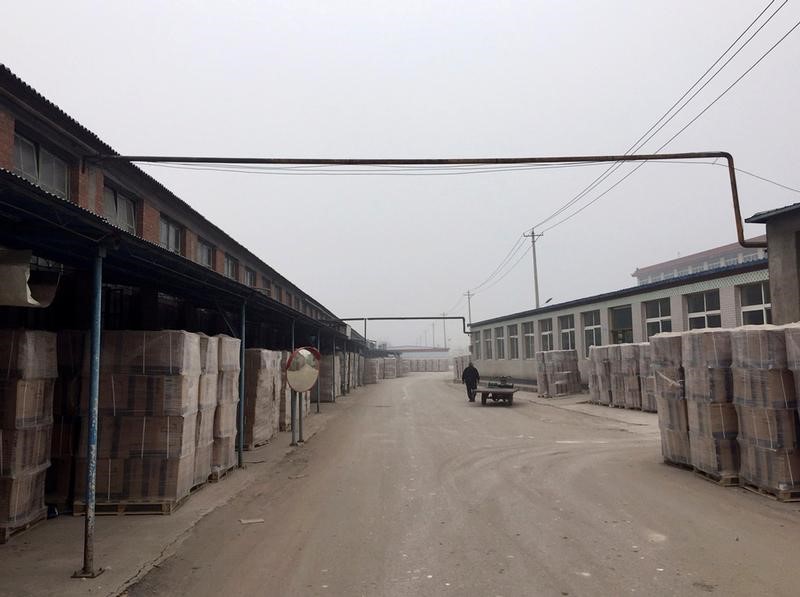 © Reuters. A man walks inside a toilet factory in Tangshan