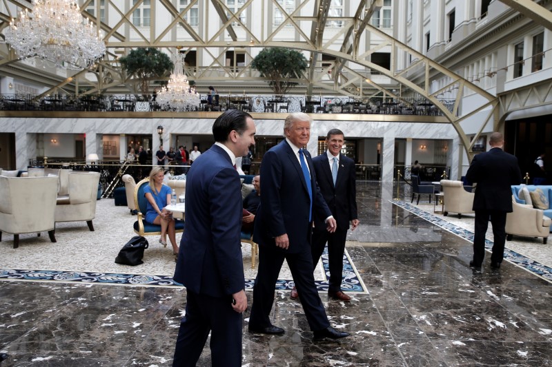 © Reuters. Republican presidential nominee Donald Trump walks through the atrium of his new Trump International Hotel in Washington