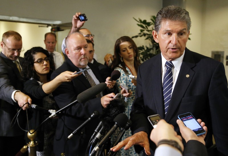 © Reuters. Manchin talks to reporters outside of a closed-door Senate Armed Services Committee briefing on the Bergdahl prisoner swap at the U.S. Capitol in Washington