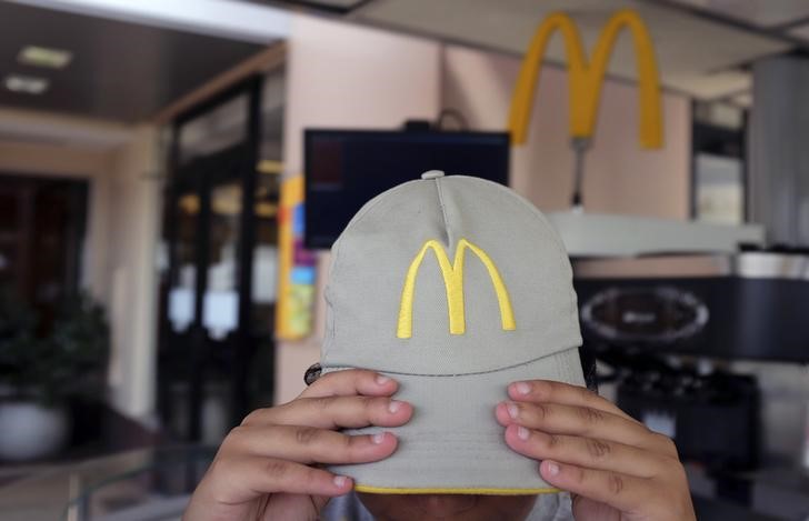 © Reuters. The logo of McDonald's is seen on the cap of a staff member as she adjusts it at a McDonald's restaurant in Sao Paulo