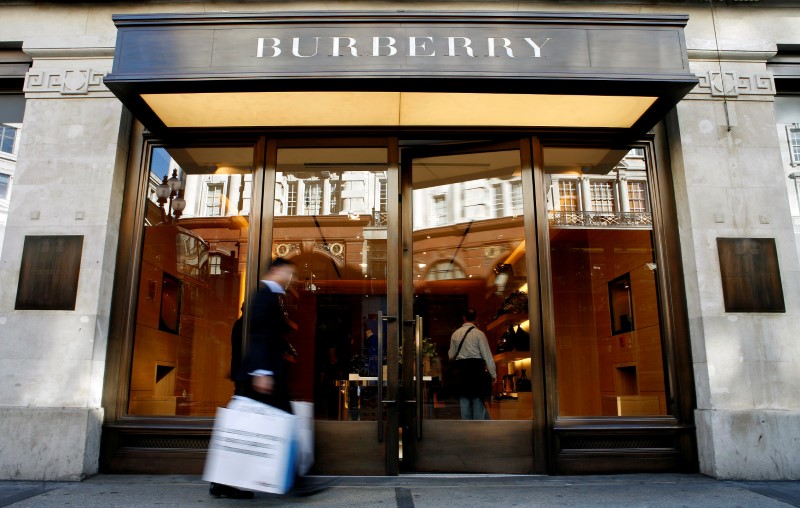 © Reuters. A customer walks in front of a Burberry store in central London