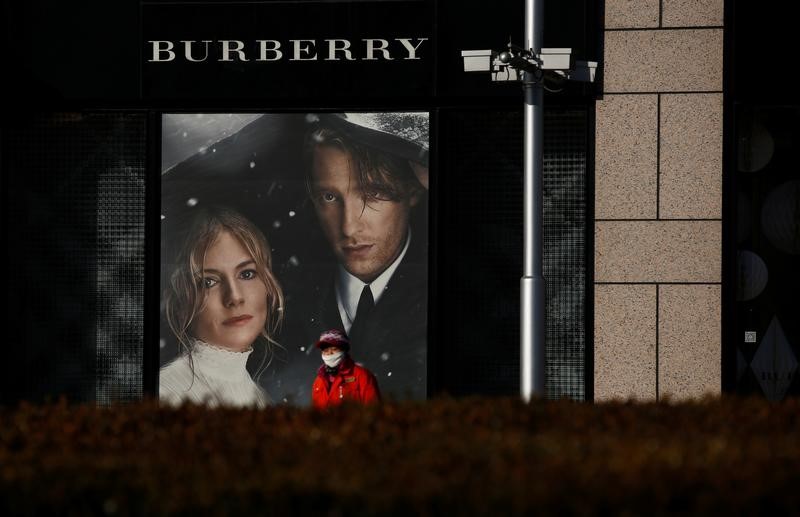© Reuters. A woman walks past a boutique of the Burberry luxury goods company in Beijing