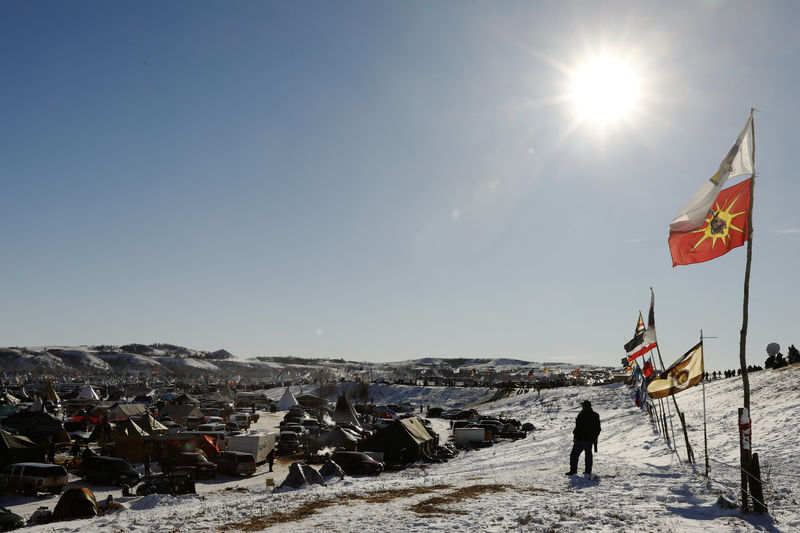 © Reuters. A man stands near Highway 1806 just outside of the Oceti Sakowin camp as "water protectors" continue to demonstrate against plans to pass the Dakota Access pipeline near the Standing Rock Indian Reservation, near Cannon Ball, North Dakota