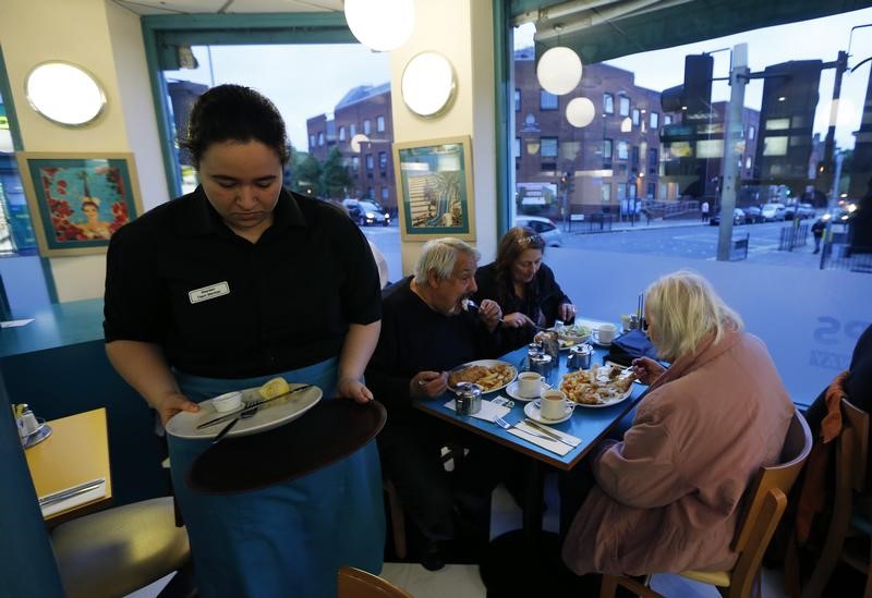 © Reuters. Customers are seen dining at Mr Fish in north London