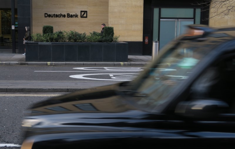 © Reuters. A London taxi is driven past a Deutsche Bank building in the City of London