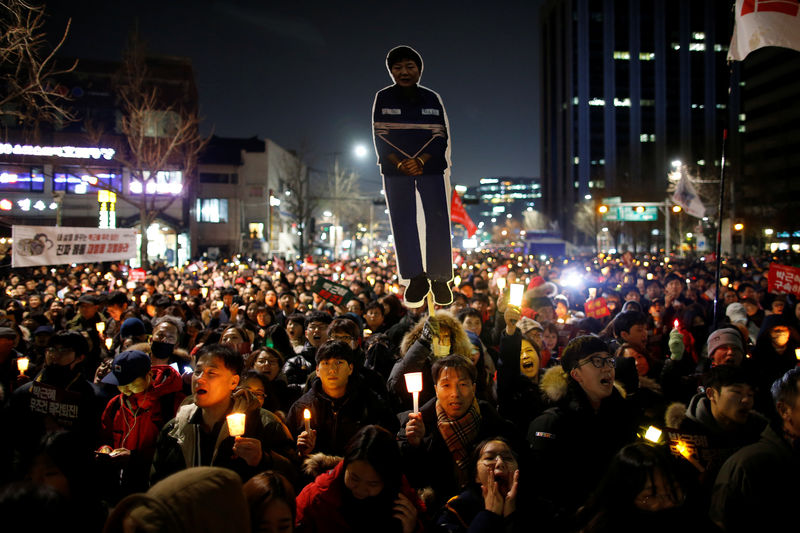 © Reuters. People march toward the Presidential Blue House during a protest calling for South Korean President Park Geun-hye to step down in central Seoul