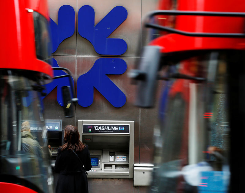 © Reuters. People stand near a branch of Royal Bank of Scotland (RBS) in London
