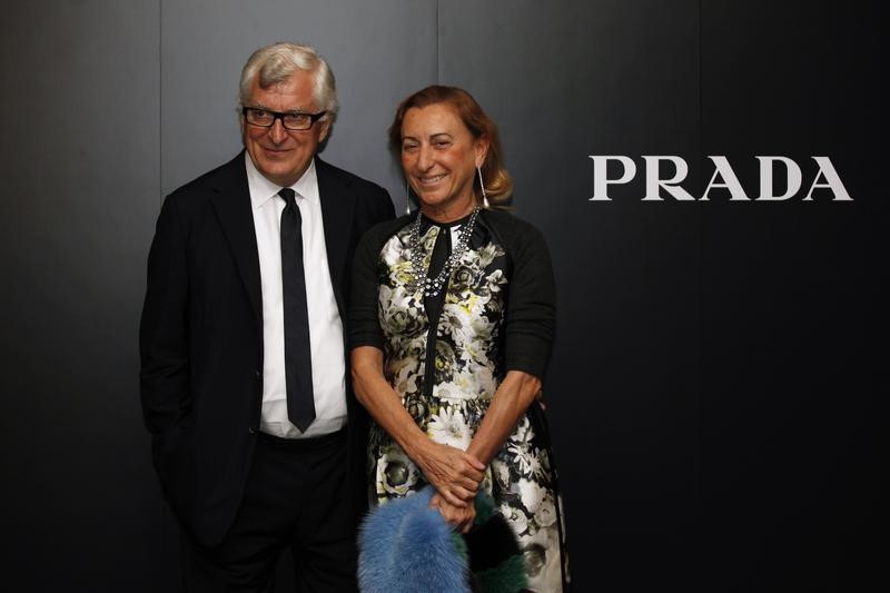 © Reuters. Prada's Chief Executive Patrizio Bertelli poses with his wife, fashion designer Prada, after attending fashion show in Hong Kong