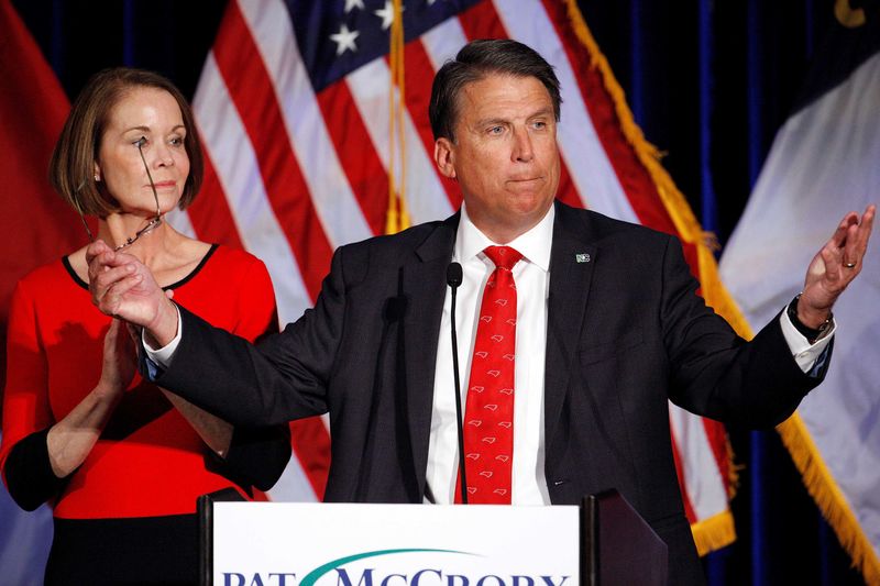 © Reuters. North Carolina Governor Pat McCrory tells supporters that the results of his contest against Democratic challenger Roy Cooper will be contested, while his wife Ann looks on, in Raleigh, North Carolina