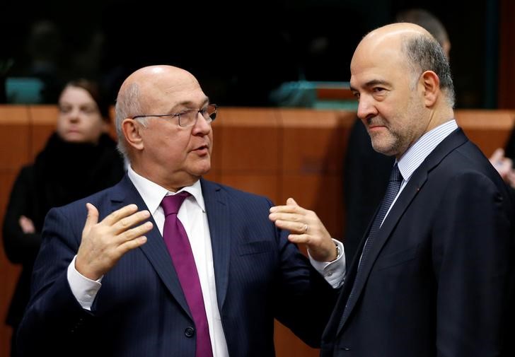 © Reuters. Michel Sapin e Pierre Moscovici (dx) durante la riunione dei ministri delle Finanze della zona euro a Bruxelles