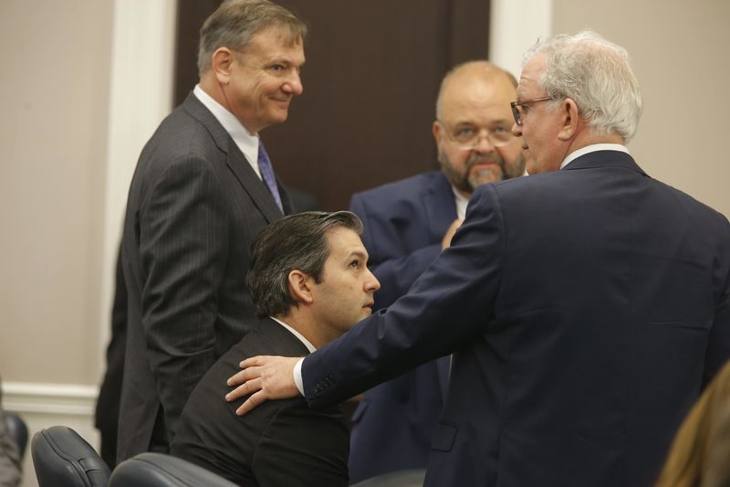 © Reuters. Defense attorneys McCune, Savage and Shealy surround former North Charleston police officer Slager after a note was sent by the jury as they continue to deliberate at the Charleston County court in Charleston