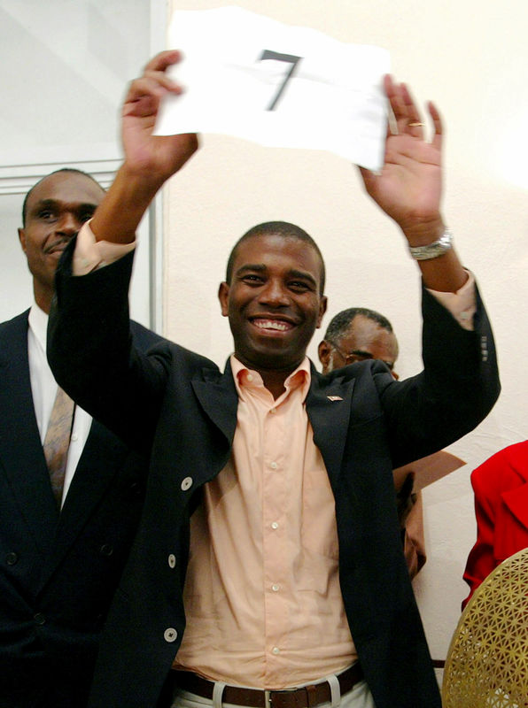 © Reuters. Guy Philippe holds his number while running as a candidate for the National Reconstruction Front (FNR) in the presidential election in Port-au-Prince