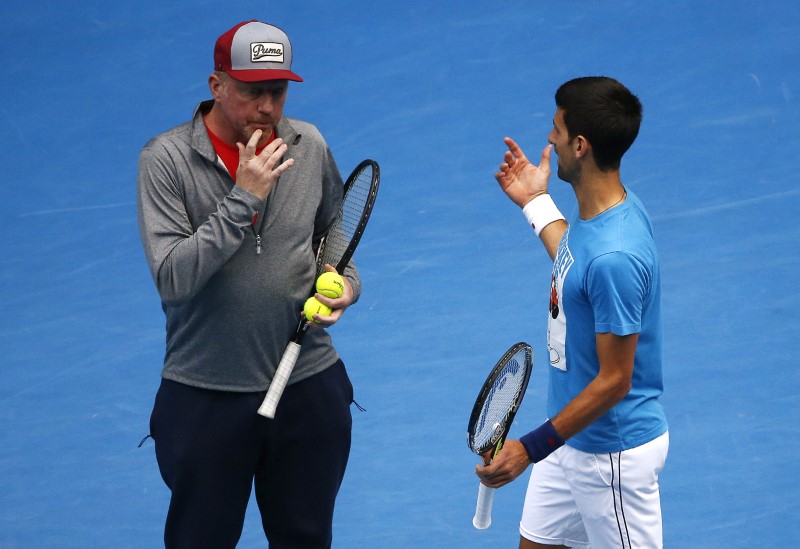 © Reuters. Serbia's Djokovic talks with his coach Becker during a practice session on the eve of his final match against Britain's Murray, at the Australian Open tennis tournament at Melbourne Park