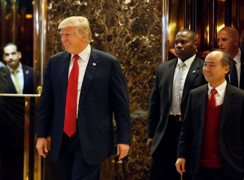 © Reuters. U.S. President-elect Donald Trump and Softbank CEO Masayoshi Son exit together after meeting at Trump Tower in Manhattan, New York