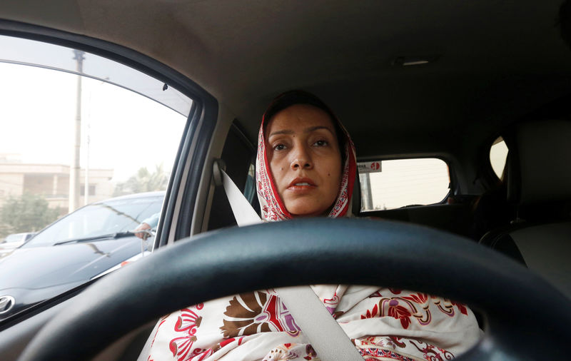 © Reuters. Aasia Abdul Aziz, one of the pioneer women drivers of Careem, drives her car in Karachi