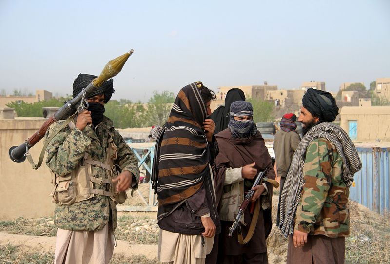 © Reuters. File picture of members of the Taliban at the site of the execution of three men accused of murdering a couple during a robbery in Ghazni Province