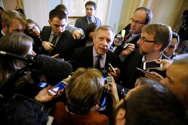 © Reuters. Durbin talks with reporters after the weekly Democratic caucus policy luncheon at the U.S. Capitol in Washington