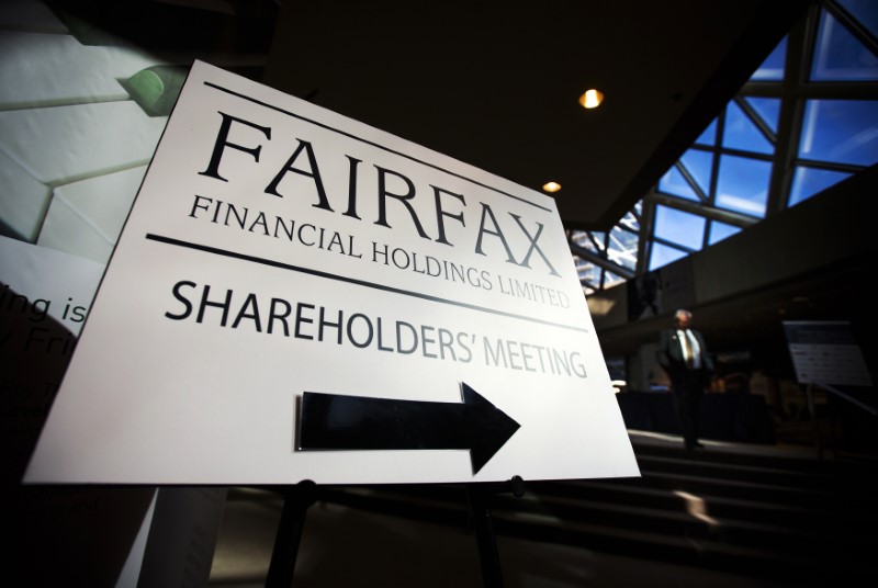 © Reuters. A man walks past a Fairfax Holdings sign directing shareholders to the meeting, at the annual general meeting for shareholders in Toronto