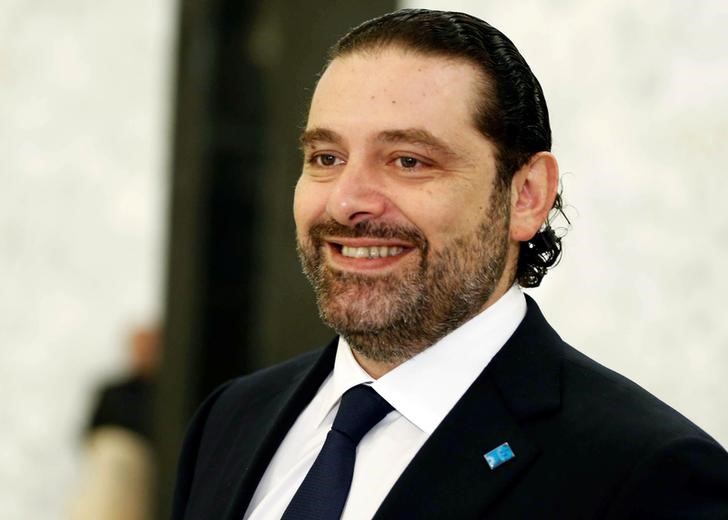 © Reuters. Lebanese Prime Minister-designate Saad al-Hariri reacts at the presidential palace in Baabda, near Beirut