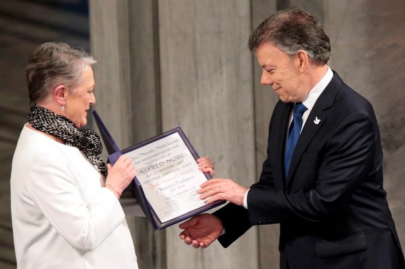 © Reuters. Nobel Peace Prize laureate Colombian President Juan Manuel Santos receives the medal and diploma from the Norwegian Nobel Committee member Berit Reiss-Andersen during the Peace Prize awarding ceremony at the City Hall in Oslo