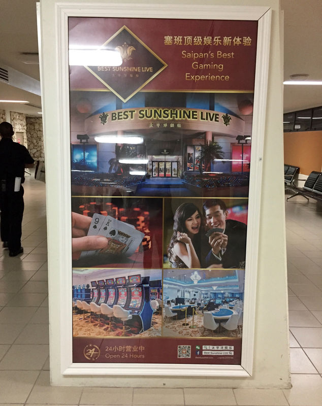 © Reuters. An advertisement in simplified Chinese characters and English promoting gaming at Best Sunshine Live is displayed at Saipan, a U.S. South Pacific island