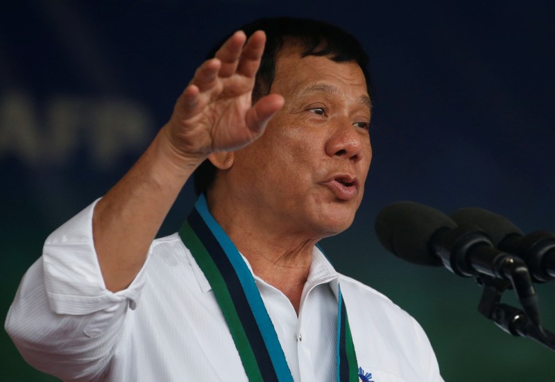 © Reuters. Philippine Pesident Rodrigo Duterte speaks during the change of command for the new Armed Forces chief at a military camp  in Quezon city, Metro Manila