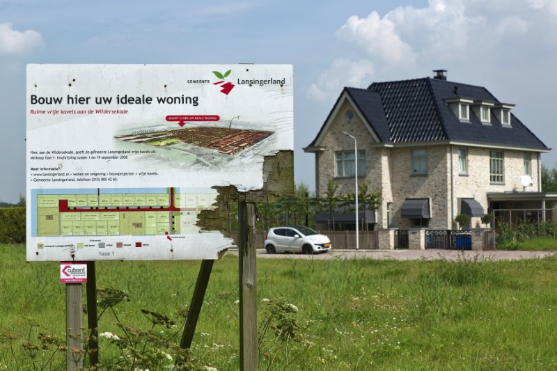 © Reuters. Weathered wooden sign advertising new luxury housing is seen in Lansingerland