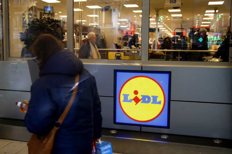 © Reuters. A woman walks past a logo inside a store of discount supermarket chain Lidl in Paris