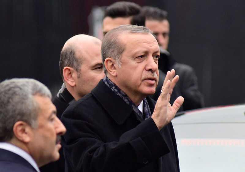 © Reuters. Turkish President Erdogan greets people as he arrives at the site of Saturday's blasts in Istanbul