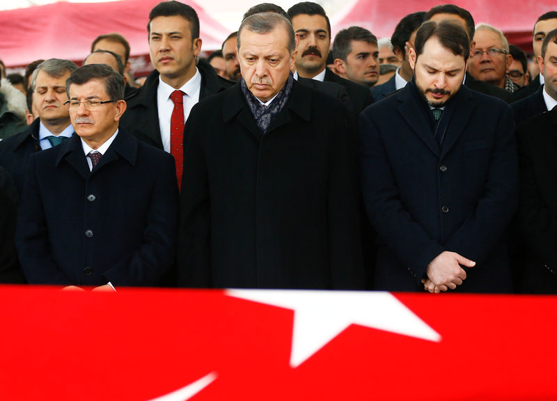 © Reuters. Turkish President Erdogan attends a funeral ceremony for police officer Hasim Usta who was killed in Saturday's blasts in Istanbul