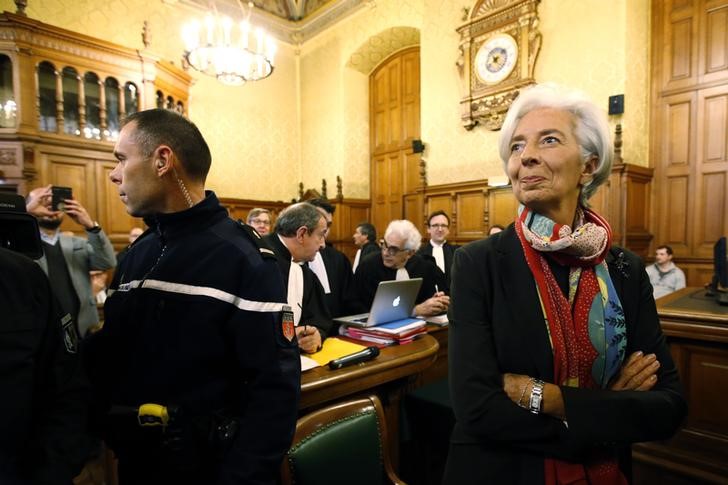 © Reuters. Managing Director of the International Monetary Fund Christine Lagarde reacts before the start of her trial about a state payout in 2008 to a French businessman, at the courts in Paris