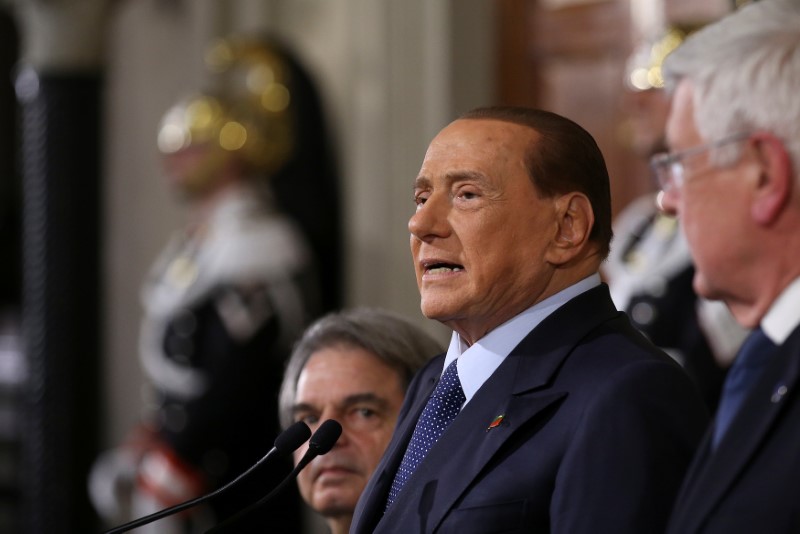 © Reuters. Italy's former Prime Minister Silvio Berlusconi speaks at the end of his consultations with Italian President Sergio Mattarella at the Quirinale Palace in Rome