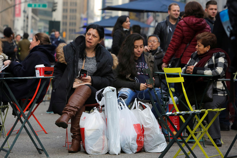 © Reuters. A woman sits in Herald Square with bags of shopping during Black Friday sales in Manhattan, New York, U.S.