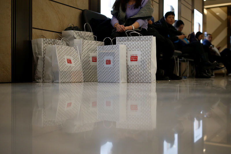 © Reuters. Shopping bags are seen at a Lotte duty free shop in Seoul