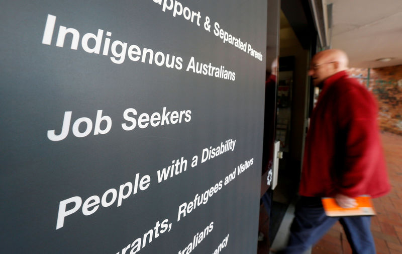 © Reuters. A man walks into a Centrelink, part of the Australian government's department of human services where job seekers search for employment, in a Sydney suburb