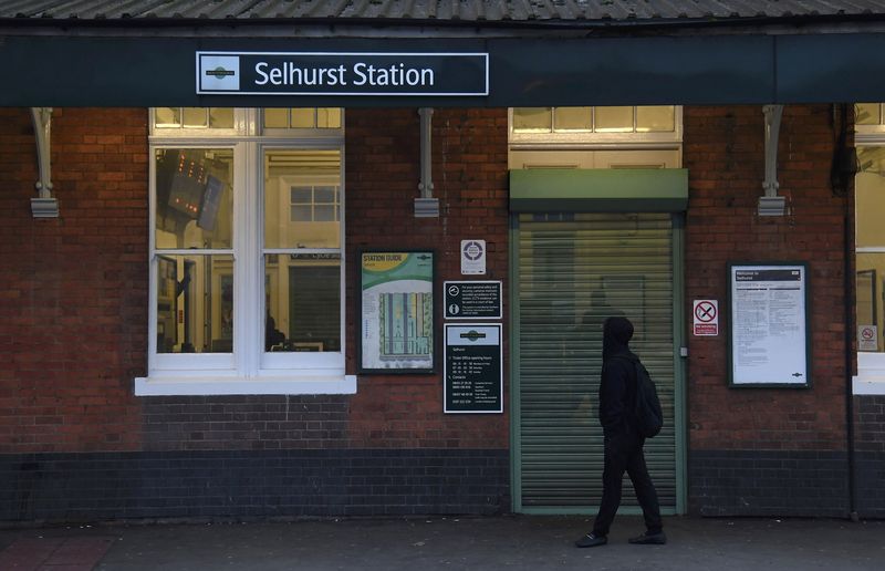 © Reuters. A youth views signs outside the closed entrance of Selhurst Station as strikes continue on the Southern rail network, in London, Britain