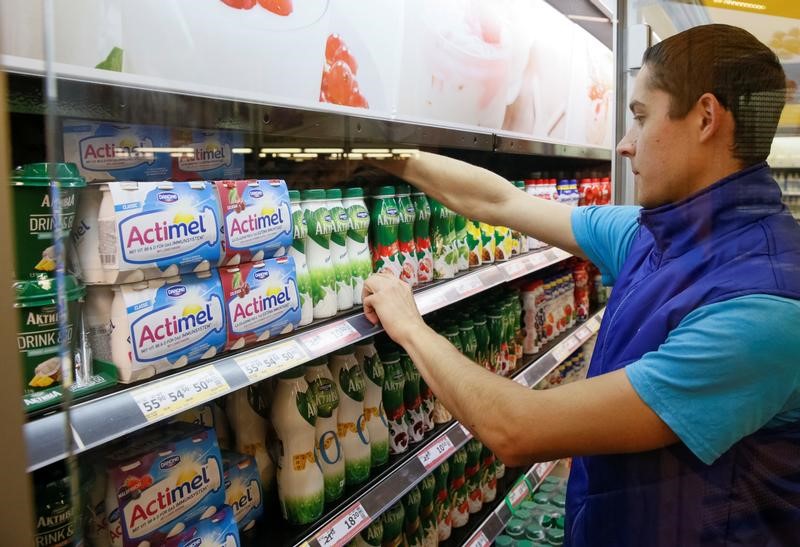 © Reuters. Employee sorts Danone dairy products at Metro cash and carry store in Kiev