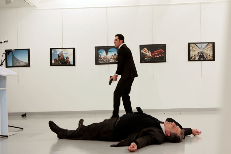 © Reuters. Russian Ambassador to Turkey Andrei Karlov lies on the ground after he was shot by unidentified man at an art gallery in Ankara