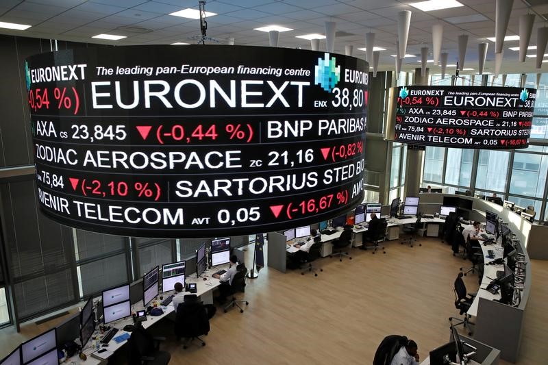 © Reuters. Company stock price information is displayed on screens as they hang above the Paris stock exchange, operated by Euronext NV, in La Defense business district in Paris