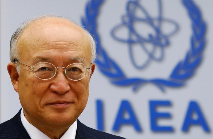© Reuters. IAEA Director General Amano smiles as he waits for a board of governors meeting to begin at the IAEA headquarters in Vienna
