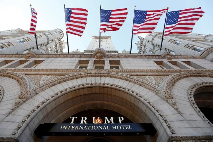 © Reuters. Flags fly above the entrance to the new Trump International Hotel on its opening day in Washington