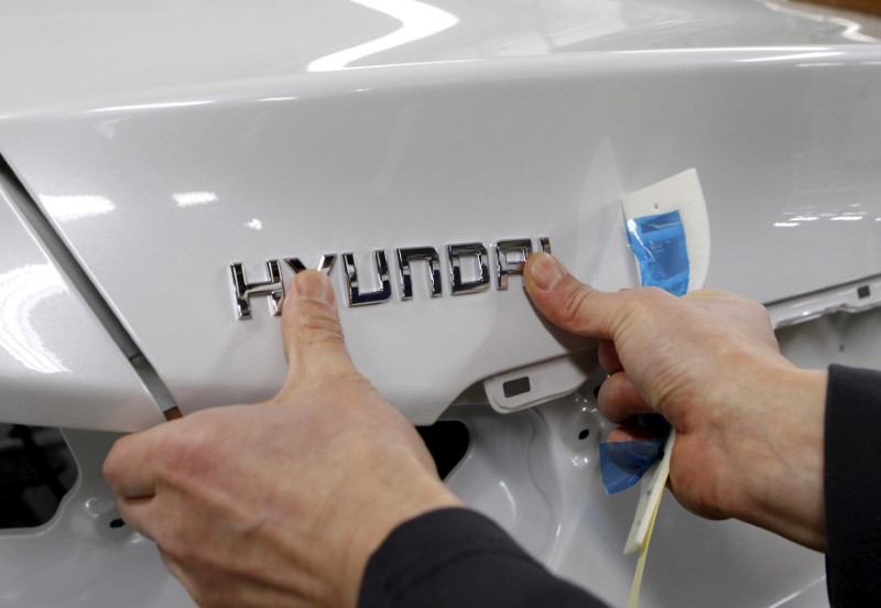 © Reuters. A worker fixes the Hyundai logo on a vehicle at a plant of Hyundai Motor in Asan, south of Seoul