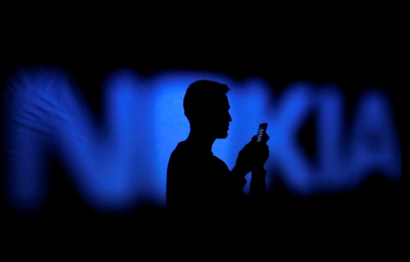 © Reuters. A photo illustration of a man silhouetted against a Nokia logo