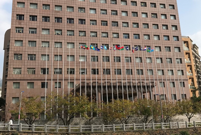 © Reuters. A Solomon Islands flag waves at the top of a flagpole which at the bottom reads "Sao Tome" in front of a building housing most of the embassies of Taiwan's official allies, in Taipei