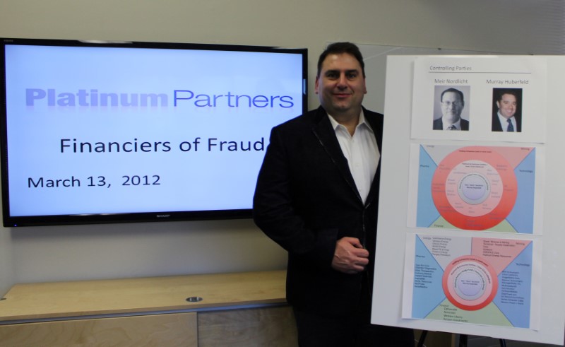 © Reuters. Michael Petras stands in front of parts of the PowerPoint presentation he gave to U.S. regulators in 2012 about Platinum Partners in Los Altos, California in this December 22, 2016 handout photo