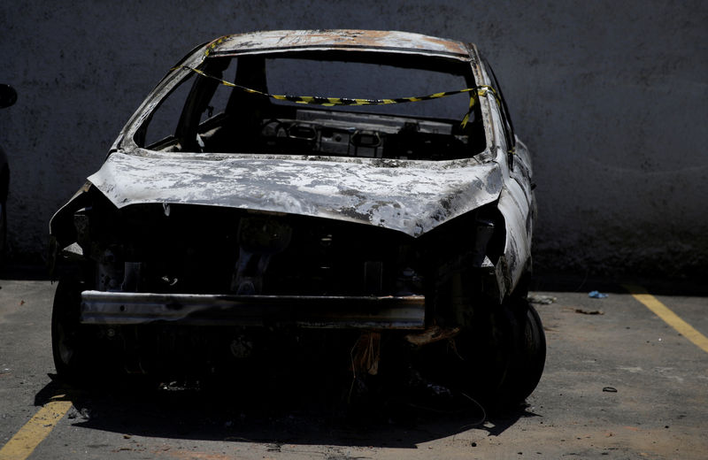 © Reuters. A burned car in which a body was found during searches for the Greek Ambassador for Brazil Kyriakos Amiridis, is pictured at a police station in Belford Roxo