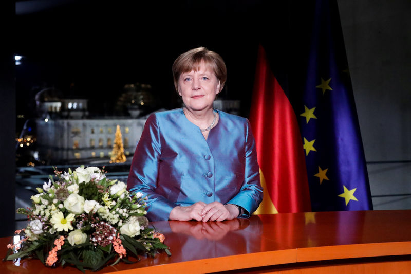 © Reuters. German Chancellor Angela Merkel poses for photographs after the television recording of her annual New Year's speech at the Chancellery in Berlin